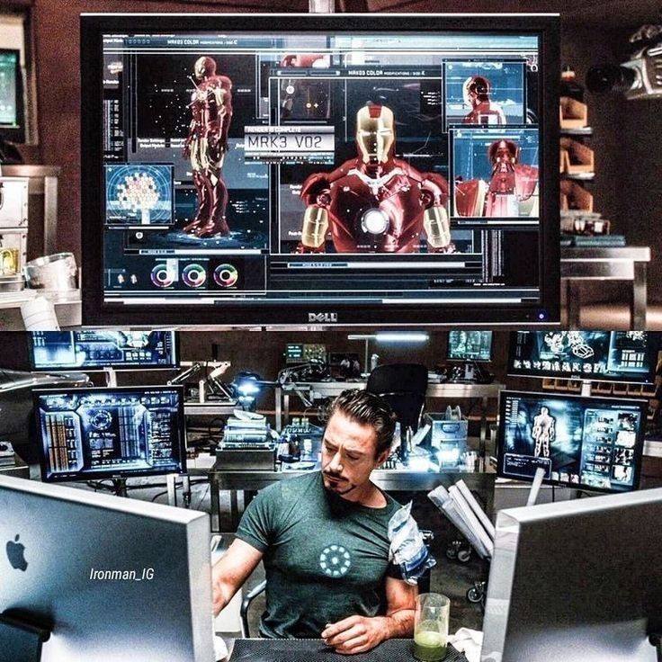 Tony Stark iterando em cima do modelo 3D do Mark III numa das suas bancadas, cercado de monitores com variações do design: é literalmente assim que trabalho de engenharia de verdade acontece, com IA ou sem
